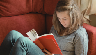 Girl reading a science biography